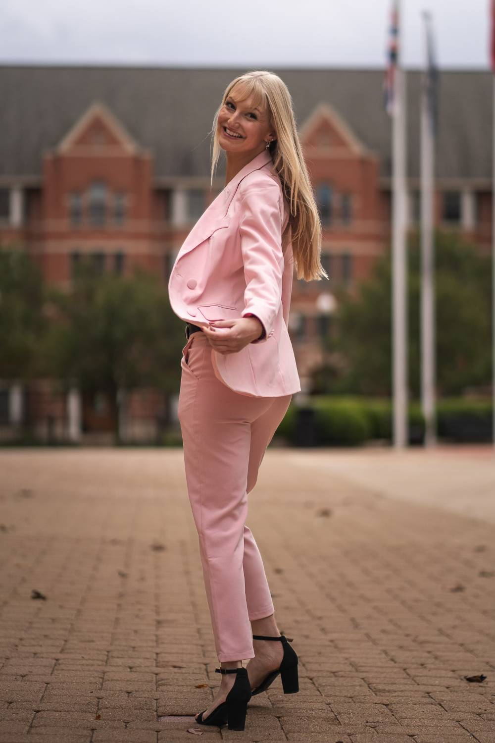 Image 1 of 2 Female student in suit walking outside